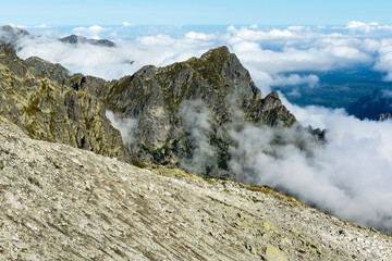 The grassy rocky massif of Mlynarz (Mlynar) and the surrounding puffy white clouds. Tatra Mountains.