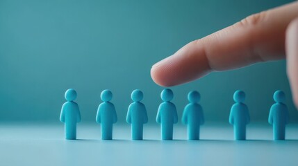 Finger Choosing One Person from a Line of Blue Figurines