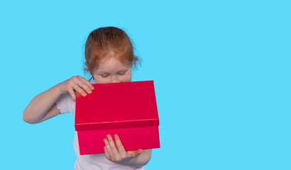 Curious Child Exploring  Bright Red Gift Box Against  Vibrant Blue Background