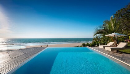 Obraz premium Beach resort with infinity pool overlooking ocean.