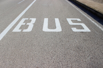 bus lane with some letters that say bus