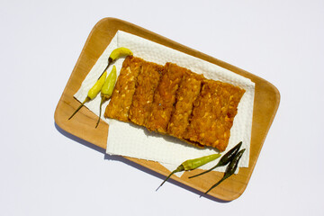 Fried tempeh, also known as “tempe goreng” from Indonesia. It is a popular dish in Indonesia made from tempeh, which is a traditional soy product.