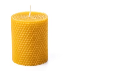 Unlit unused bees wax yellow honeycomb honey comb candle isolated on white background with copy space. Perfect holiday or birthday gift giving idea comes in scented in various aromas.