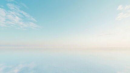 Fototapeta premium A serene blue sky with soft white clouds reflected in a calm body of water, creating a peaceful and tranquil scene.