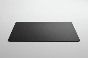 Black Rectangular Mouse Pad on a White Surface