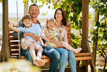 Portrait, swing and parents with kids in garden for bonding, fun relationship and relax together. Backyard, happy family and mom, dad and children on bench with smile for playing outdoors on weekend