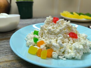 Homemade rustic crumbly cottage cheese on a plate. Still-life. High quality photo