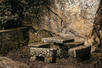 Ancient stone table and benches in a forest setting in San Marino