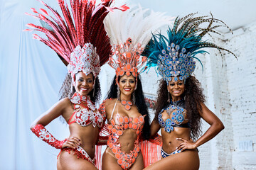 Carnival, costume and friends in portrait for tradition, celebration and expression of Brazilian culture. Festival, women and dancers with hug for performance, creativity and energy in music event
