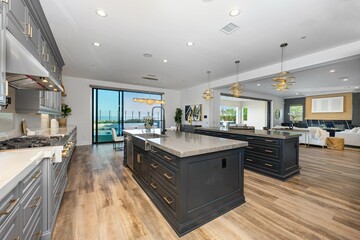 Modern open-concept kitchen with dark cabinetry and island