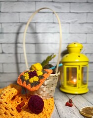 Cozy autumn photo with a cup of tea, flashlight, knitting, leaves and decor 