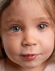 Innocent Close-Up of Young Girl with Gentle Expression and Bright Eyes