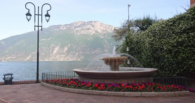 A fountain on the shores of Lake Garda in Limone Sul Garda town, Italy, Europe.