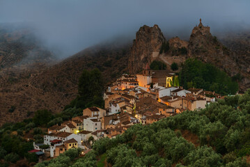 Obraz premium Castril, view at dawn of the town, the church and the rock with the remains of the castle. Granada.