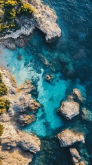 Aerial view of turquoise ocean water crashing against rocky coastline with green vegetation. Concept of nature, adventure, travel