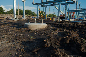 Wide view of  Electric substation under construction. Dirt piles from construction and equipment...