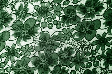 green floral pattern on fabric. wallpaper in a rustic modern design. green textile texture.