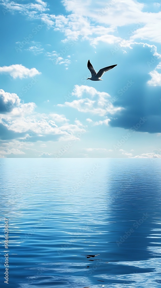 Canvas Prints Single Seagull Flying Over Tranquil Ocean with Blue Sky and Clouds