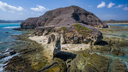 The erosion process of a beach could involve rock weathering or geological processes over a long period of time