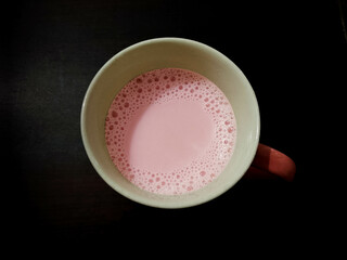 Pink Tea in the Cup isolated on black background
