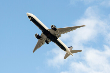 White passenger airplane flying in the sky amazing clouds in the background - Travel by air transport. High quality photo