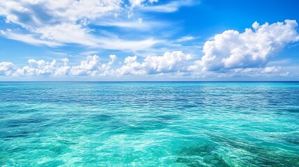 Obraz premium The ocean is calm and clear, with a few clouds in the sky