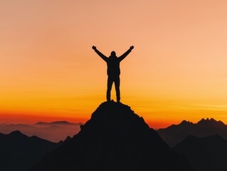 A silhouette of a person standing on a mountain peak with arms raised in victory backlit by a golden sunset The image conveys success achievement and triumph over challenges The background is expansiv