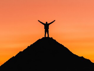 A silhouette of a person standing on a mountain peak with arms raised in victory backlit by a golden sunset The image conveys success achievement and triumph over challenges The background is expansiv