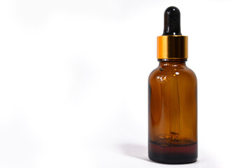 Massage oil Bottle of homeopathy Medicine closeup, Cosmetic dropper bottle on white background, homeopathic healthcare, treatment oil, isolated white background, Concept of alternative herbal medicine