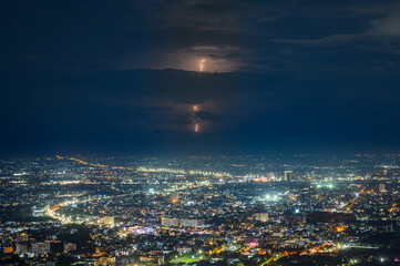 aerial view of Chiang mai City night from the Doi Suthep view point in raining storm clouds with lightning, Chiang mai,Thailand