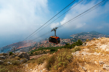 Dubrovnik cable car ascends Mount Srd, offering scenic views of Old Town & Adriatic Sea.