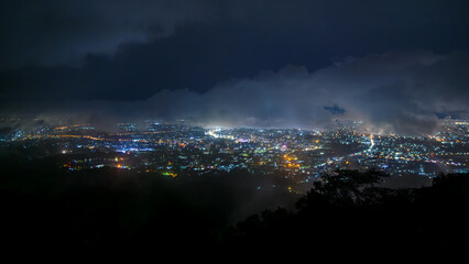 Obraz premium landscape aerial view City night light from Doi Suthep mountain view point on top of mountains with clouds, Chiang mai, Thailand