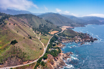 Obraz premium Beautiful landscape of Pacific Ocean coast along Highway 1 and Big Sur, aerial view, sunset, sunrise, fog. Concept, travel, vacation, weekend