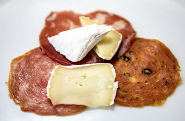 Classic appetizer with salami and camembert cheese