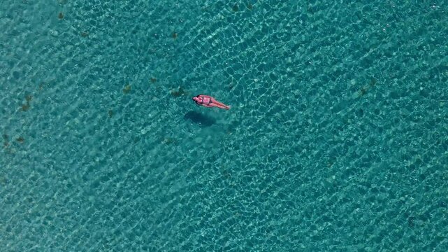 Aerial view of Pouda Beach and the pink pond behind it located opposite Elafonisos Island Peloponnese Region Greece