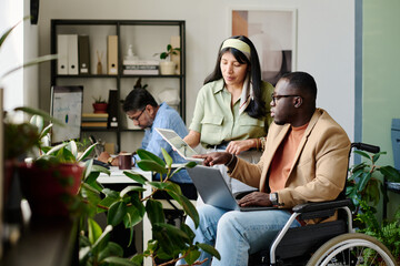 Team working together with focus on collaboration and inclusivity, featuring colleagues showing...