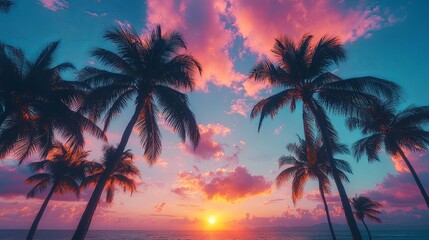 Silhouetted Palm Trees Against a Vibrant Sunset Over the Ocean
