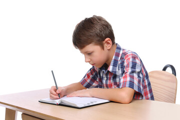 Boy with incorrect posture and notebook at wooden desk on white background
