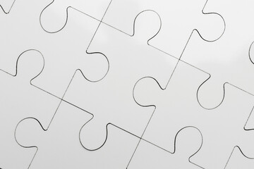 White puzzle as background, top view. Intellectual game