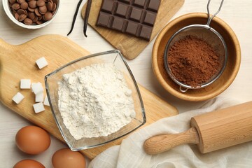 Flat lay composition with flour, eggs and other ingredients for making dough on light table