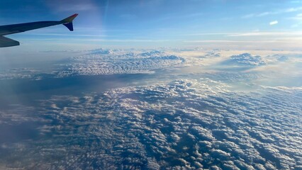 A stunning view of the clouds from an airplane window, showcasing the beauty of aerial perspective.