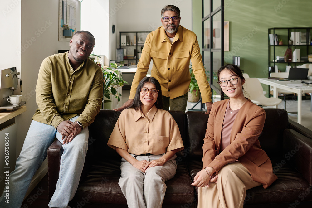 Aufkleber Group of diverse coworkers smiling and posing in office setting, displaying unity and teamwork, reflecting professional environment emphasizing collaboration