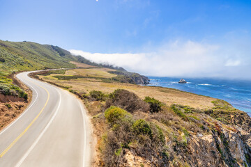 Beautiful landscape of Pacific Ocean coast along Highway 1 and Big Sur, aerial view, sunset, sunrise, fog. Concept, travel, vacation, weekend