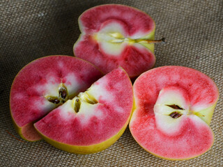 Hidden Rose apples, cut in half to show the distinctive red and white inner flesh