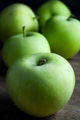 Lodi apples on a brown wood background.
