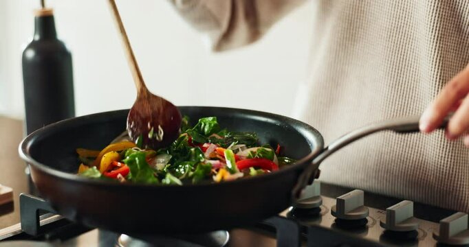 Hands, spoon and cooking in house for brunch, eating and health with nutrition, flavor and stir fry. Frying, dinner and person in kitchen for healthy breakfast, meal prep or food with diet in morning