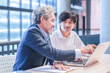 A young asian man sitting and conversation with advisor teacher,professor giving advice university...