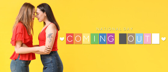 Beautiful young lesbian couple on yellow background