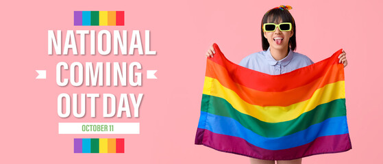 Beautiful young woman in sunglasses with LGBT flag showing tongue on pink background