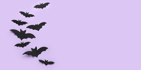 Black paper bats for Halloween party on lilac background with space for text